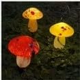 Three glass mushrooms, one red, one oragane and one yellow, on a dark background