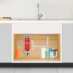 Under-cabinet view of a kitchen with plumbing and cleaning supplies.