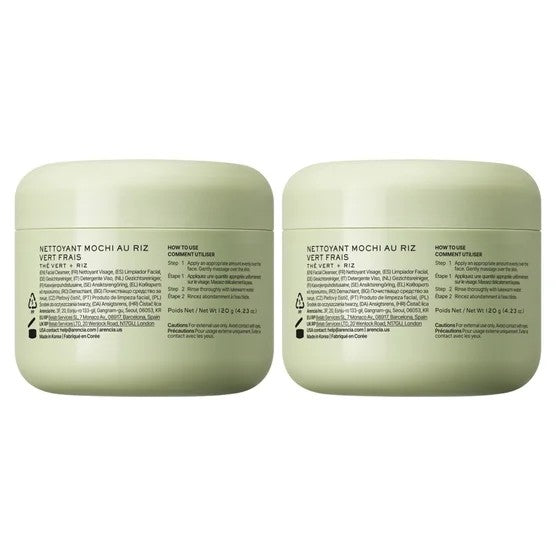 Two green jars with labels on a white background