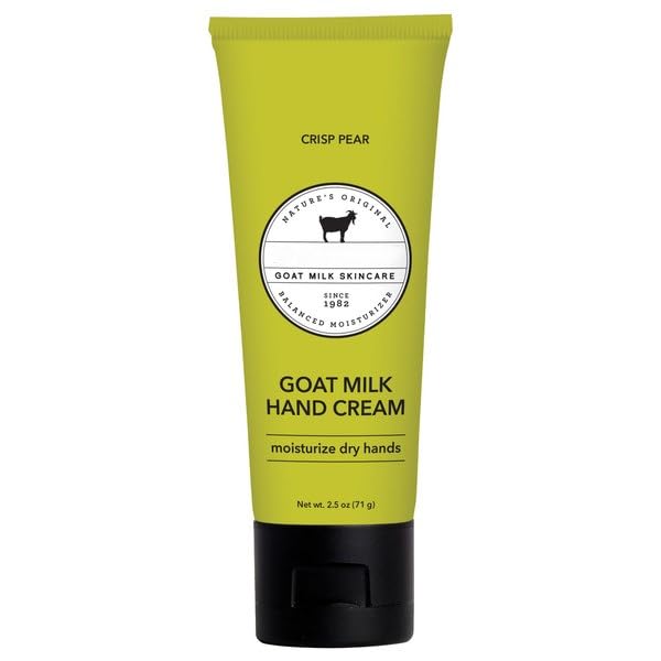 Green tube of goat milk hand cream on a white background
