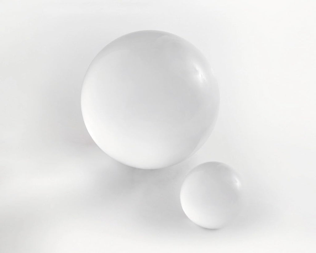Two white spheres on a light gray background