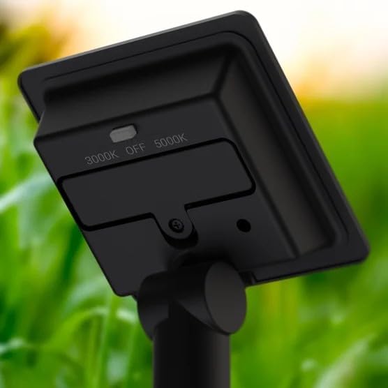 Black light fixture with adjustable temperature settings against a blurred green background