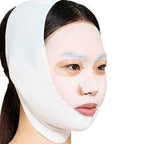 Woman wearing a white face mask with a plain background
