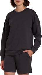 Person wearing a black sweatshirt and shorts on a white background