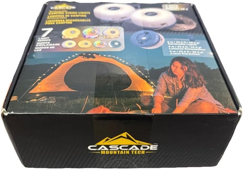 Box of Cascade Mountain Tech camping lights with a person setting up a tent on the packaging.