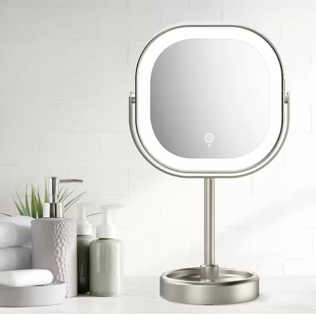 Makeup mirror with LED lights on a white surface