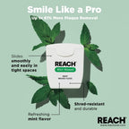 REACH mint waxed floss packaging with mint leaves on a light green background