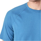 Close-up of a blue athletic shirt on a white background