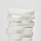 White ceramic vase with wavy texture on a light gray background