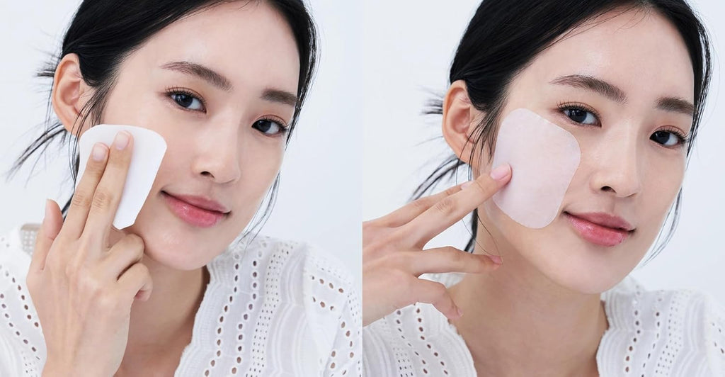 Woman applying patches to her face with a white background