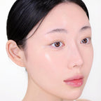Close-up of a person's face with a neutral expression on a white background