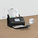 Epson document scanner on a table with dimensions labeled, next to an Epson mug.