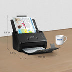 Epson scanner with dimensions displayed on a wooden surface, next to an Epson mug.
