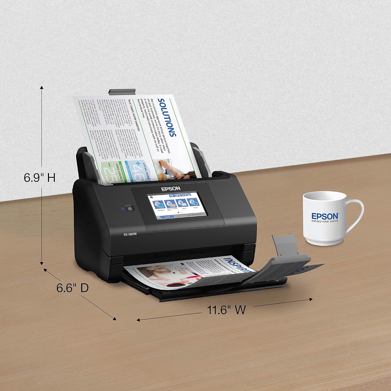 Epson document scanner on a table with dimensions labeled, next to an Epson mug.