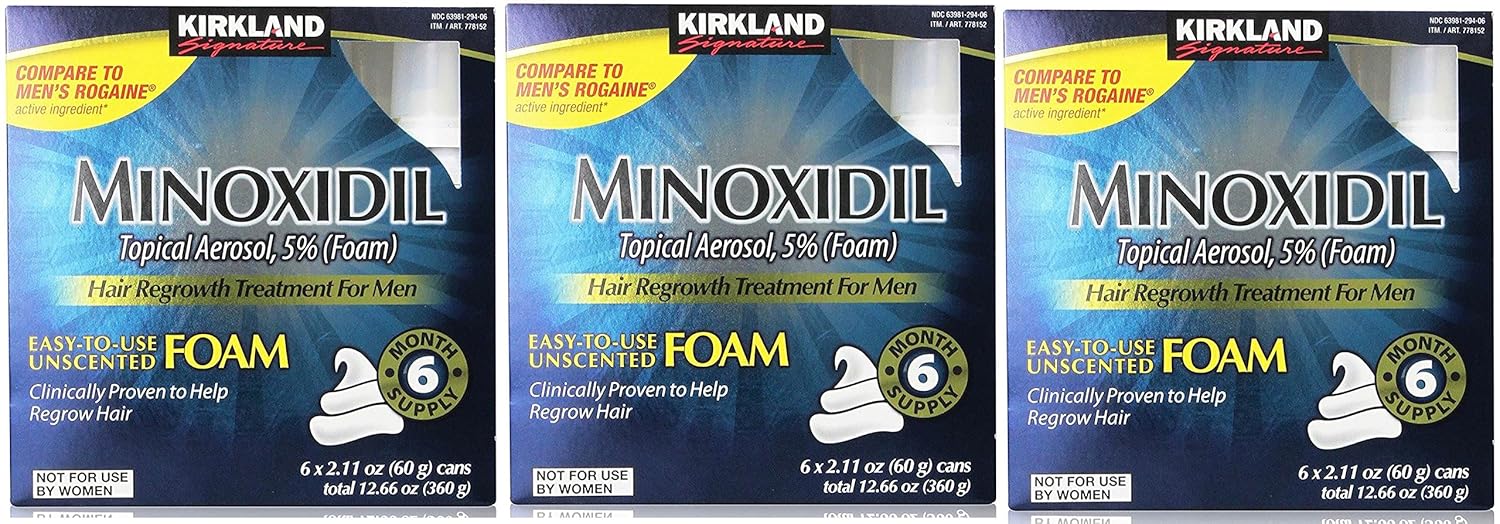 Three boxes of Kirkland Minoxidil foam hair regrowth treatment for men.