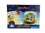 Clementoni Harry Potter Hagrid's Hut Terrarium kit box, featuring a dark blue and gold design with illustrations of the Harry Potter universe and a photo of the completed glass terrarium.